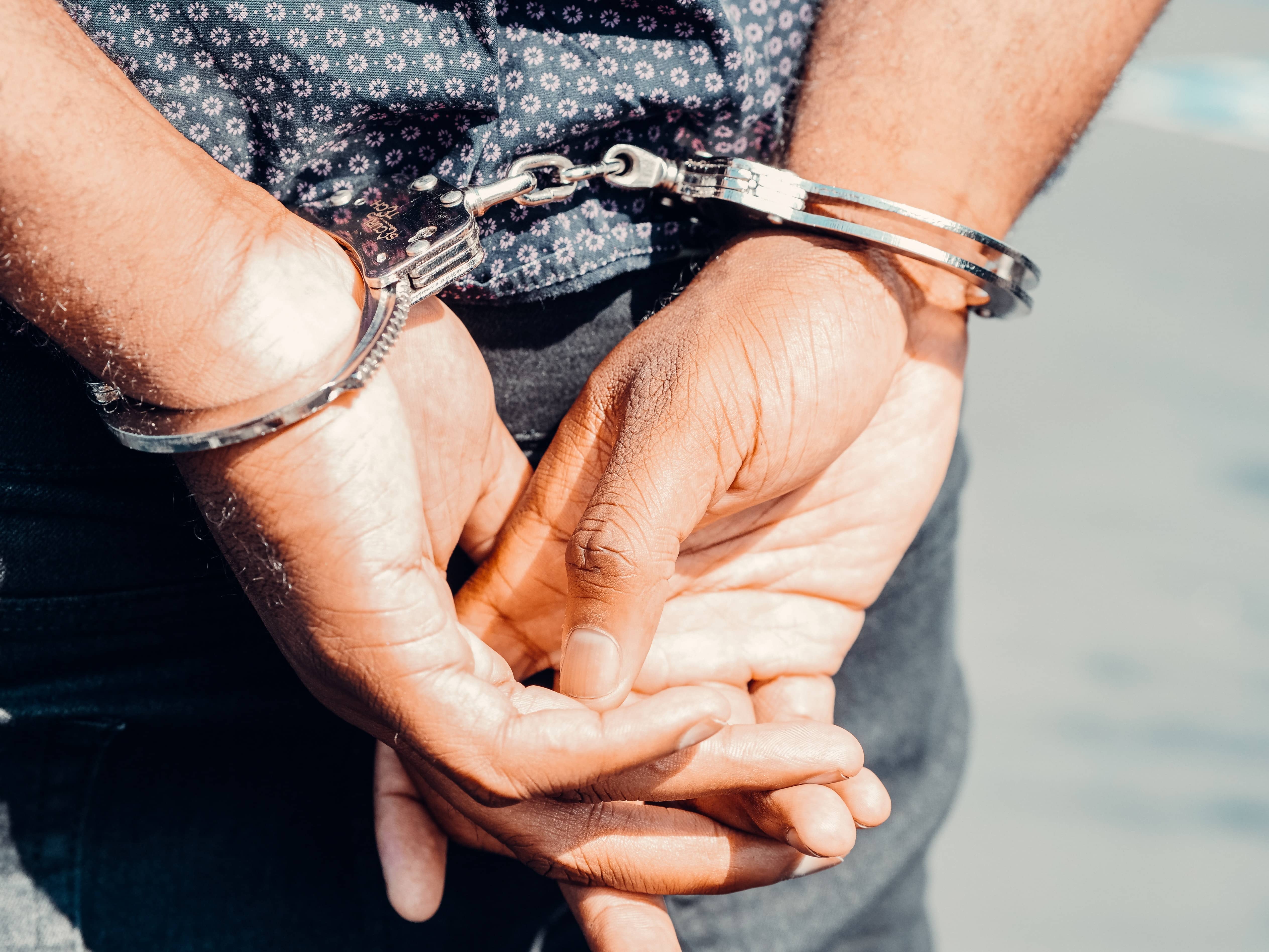 [A criminal being arrested. Photo Credits to Pexels]