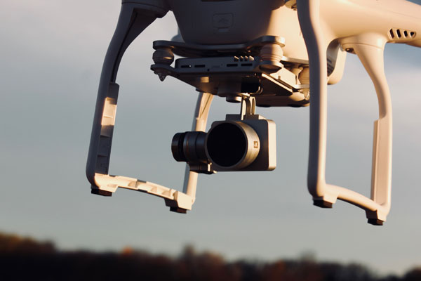 [Drone with a camera sensing ground activities. Photo Credit: Unsplash]