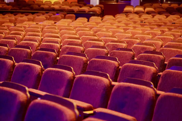 [Empty seats at a movie theater. Photo Credit: Pixabay] 