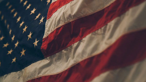 [The United States, where the brothels were formed, is represented through the flag. Photo Credit to Unsplash]